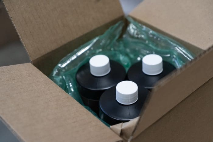 Labeled bottles packed in a shipping box