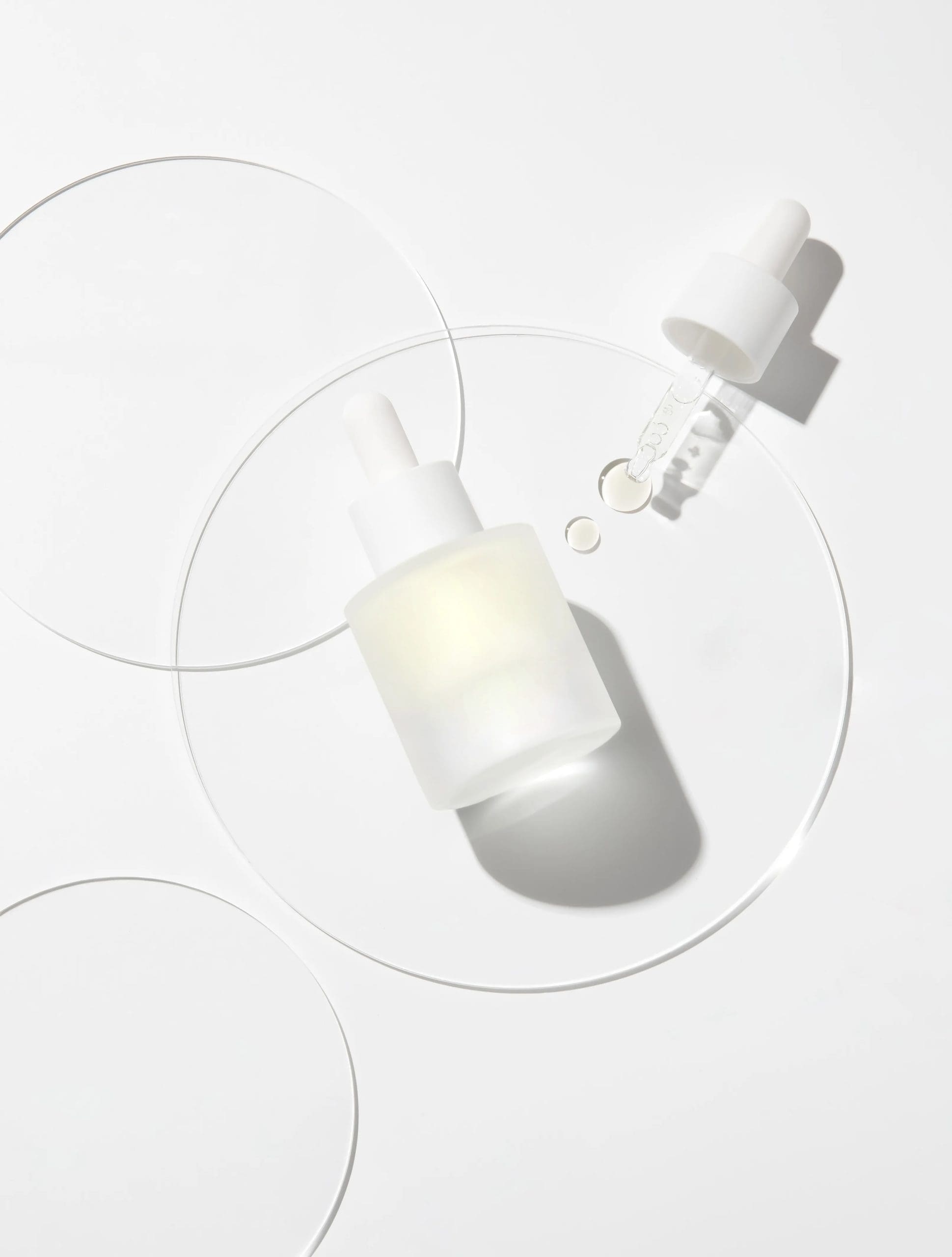 A dropper bottle and glass dishes in a formulation lab